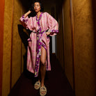 Front pose of Nicolette Linen Robe in pink striped linen with floral belt and wide sleeves