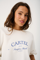 Front view of white Nina Sweater with blue Hampton Beach text and crew neckline