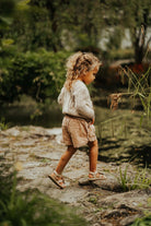 Girl wearing Niven Shorts in Rose Mocha by Donsje with Donsje Jumper and shoes