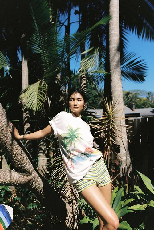 model wearing Paradise T-Shirt by Sea Street - white cotton tshirt with palm tree and dolphin