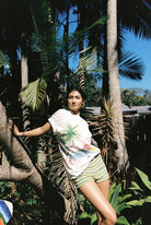 model wearing Paradise T-Shirt by Sea Street - white cotton tshirt with palm tree and dolphin