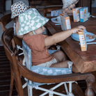 babies using IZIMINI Parker baby chair v2 as a booster seat