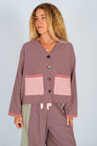 Studio shot of patchwork over shirt showing houndstooth pattern with contrasting fabric panels and pockets