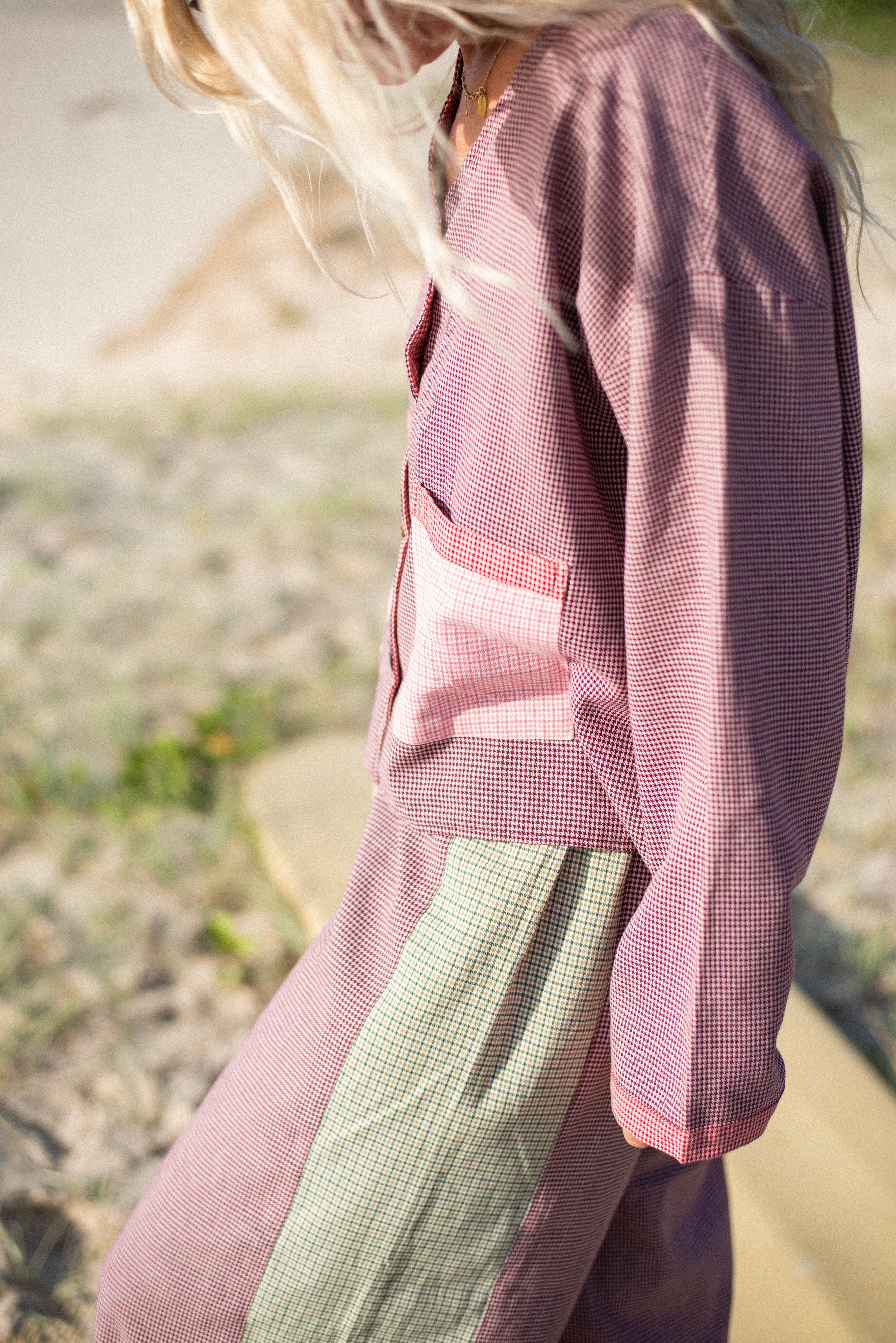 Close-up detail of houndstooth fabric texture and patchwork construction on Atmosea over shirt