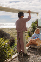 Framed view of woman in Atmosea Patchwork Pant Houndstooth Combo at coastal location