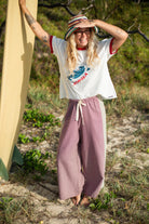 Full length rear view of woman wearing Atmosea patchwork lined pants showing side panel detail