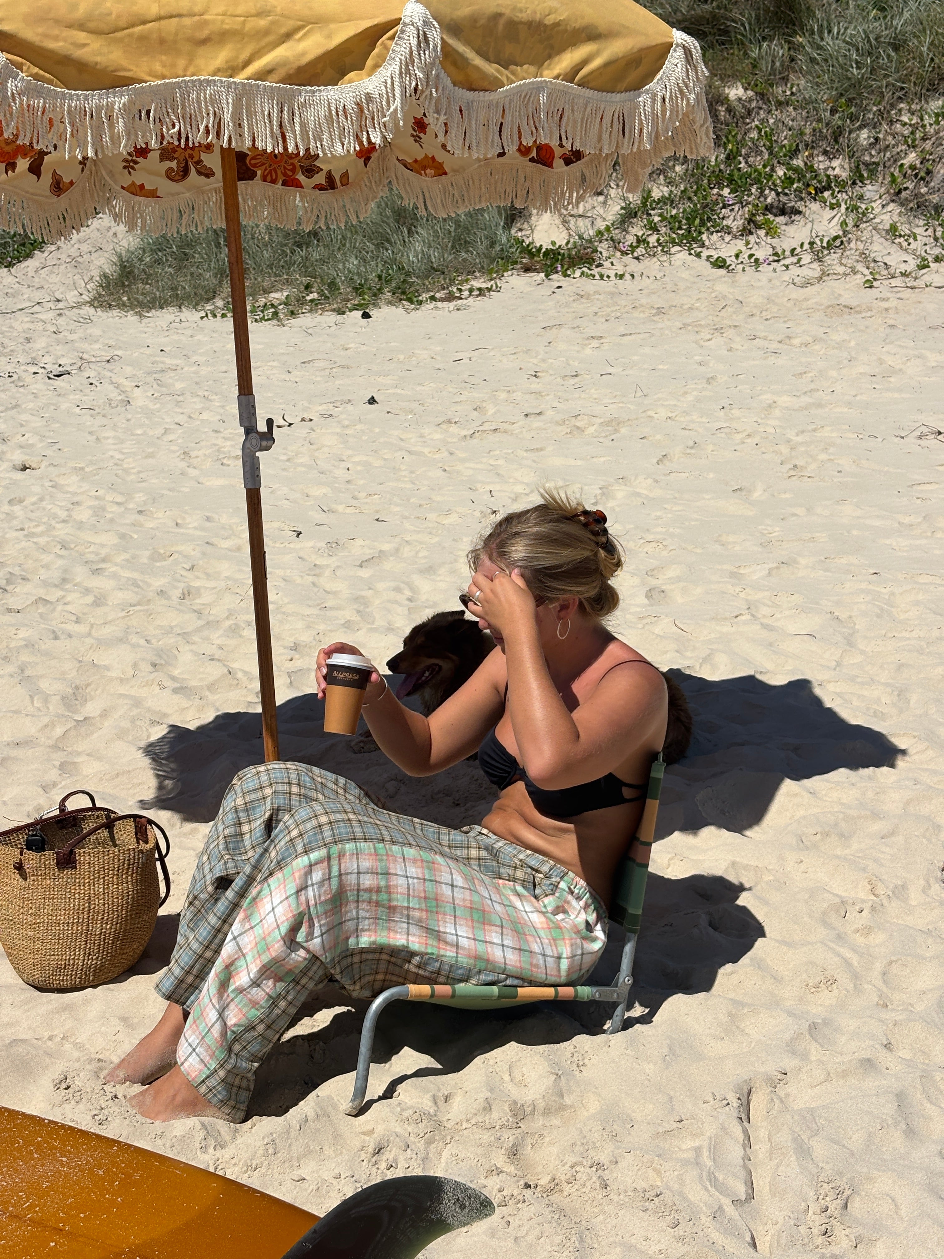 Lady sitting on beach wearing Patchwork Pant in Cottage Plaid | Atmosea