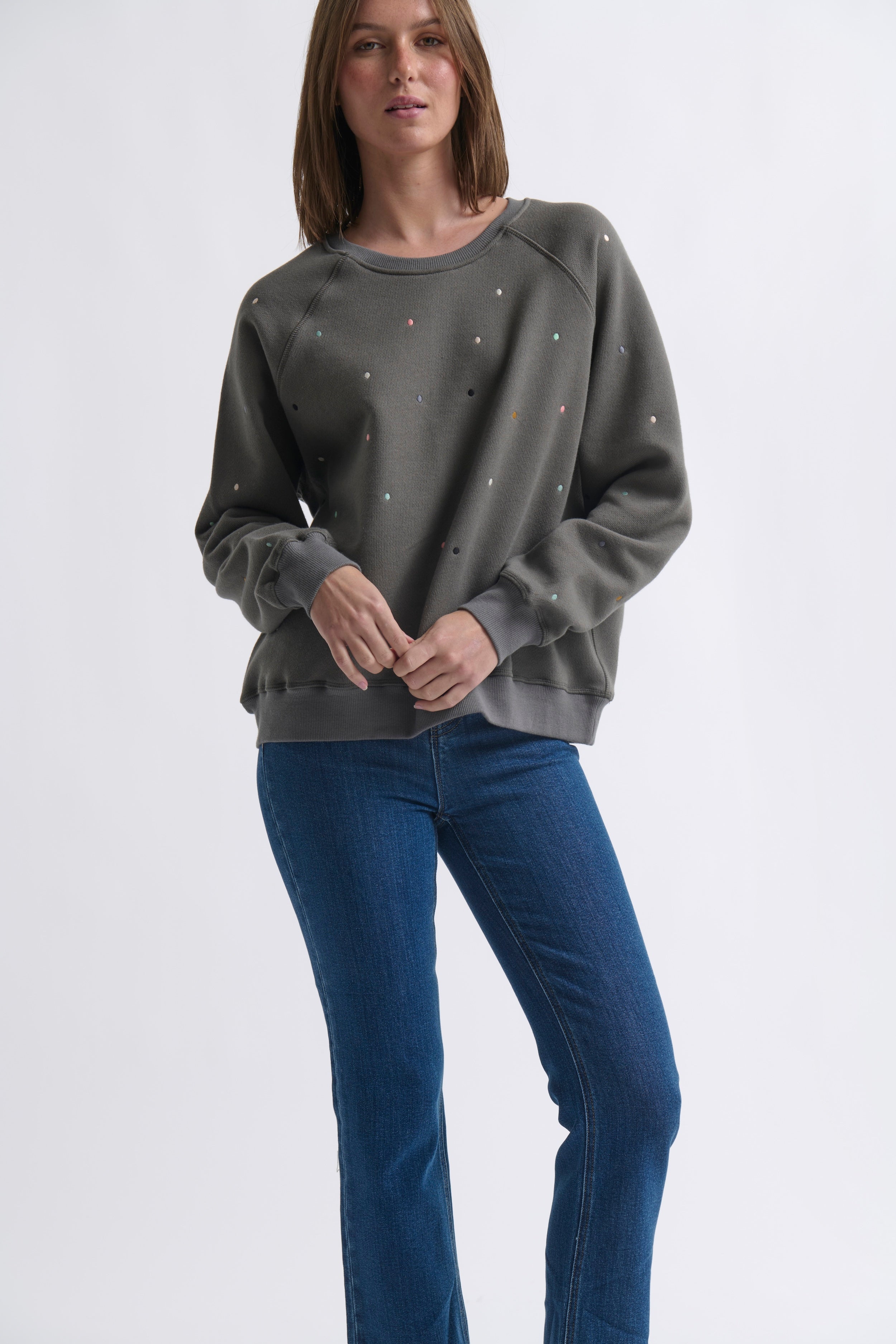 Black vintage wash sweatshirt with embroidered polka dots and raglan sleeves lifestyle shot