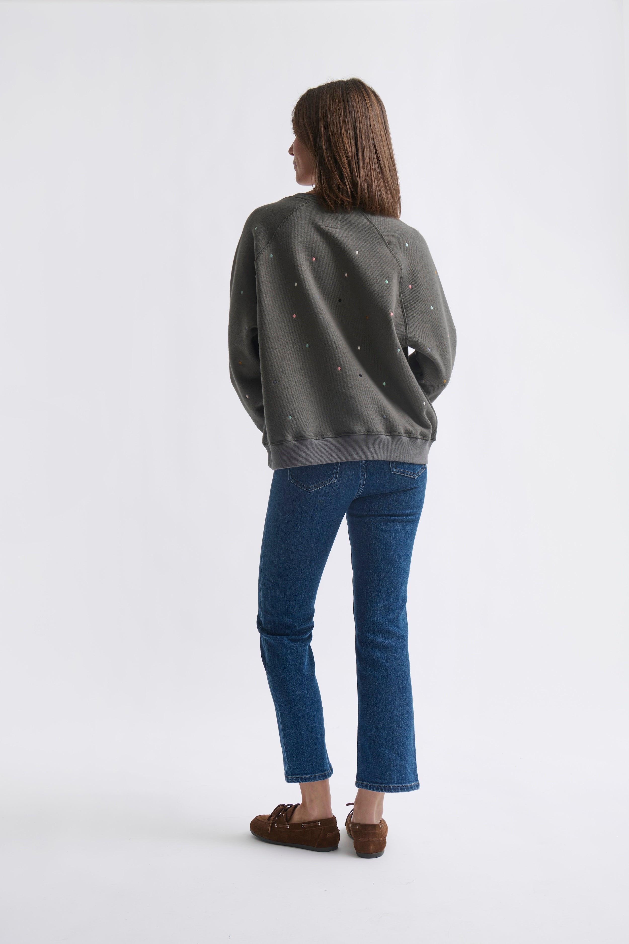 Ribbed collar cuffs and hem details on cozy black Patti sweatshirt by Kireina