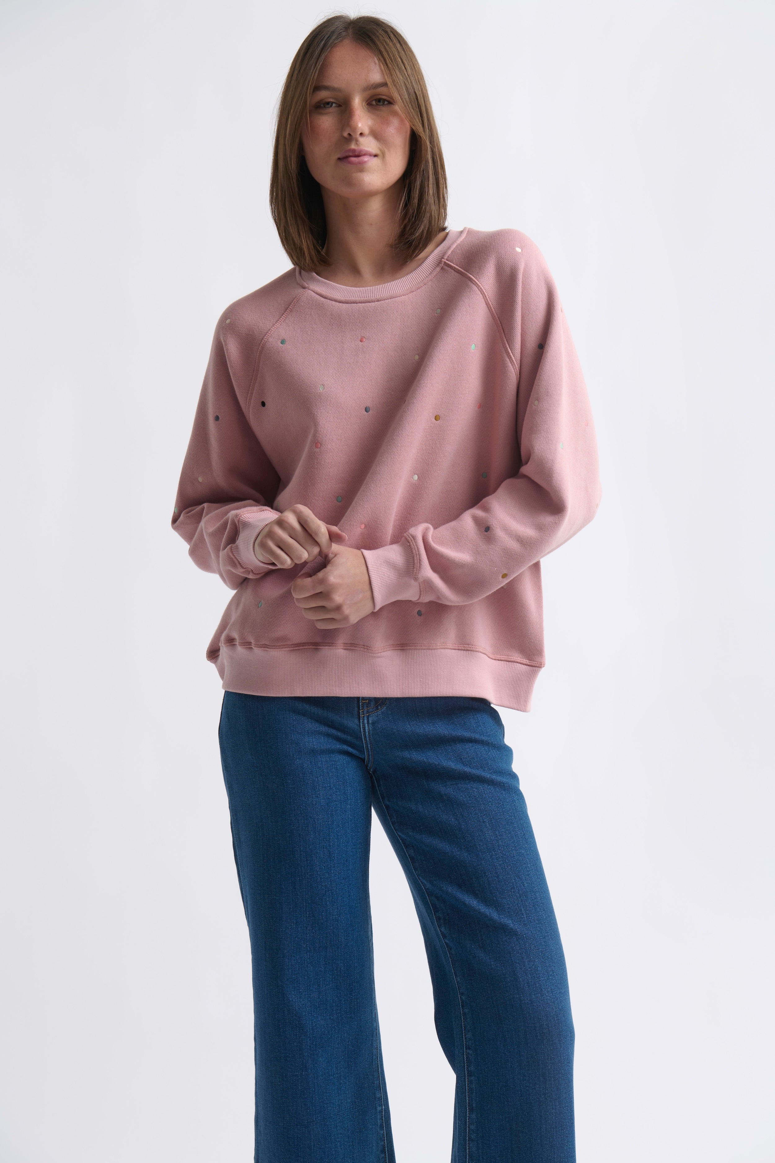 Close up detail of embroidered polka dot pattern on Kireina Patti sweatshirt French terry fabric