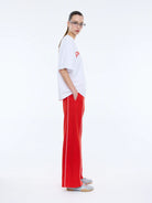 side view of model wearing Pelly Sport Tee White by Ena Pelly
