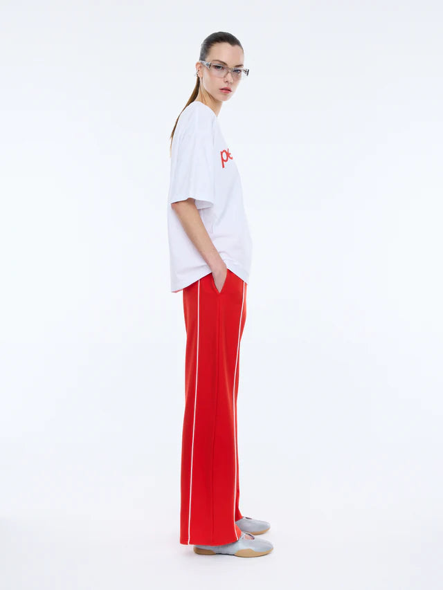 side view of model wearing Pelly Sport Tee White by Ena Pelly