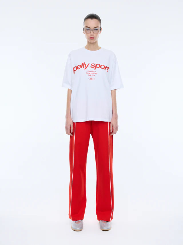 model wearing white tshirts with red writing "Pelly Sport" across the front