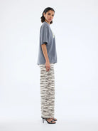 side view fo model wearing Pelly World Tour Tee - Washed Grey by Ena Pelly