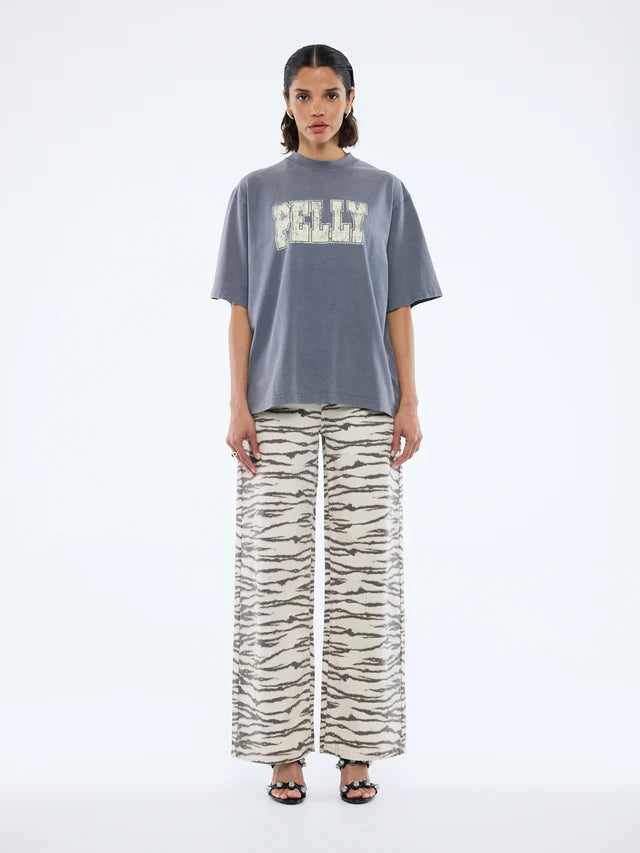 model wearing the grey tshirt with cream logo graphic - Pelly World Tour Tee - Washed Grey by Ena Pelly