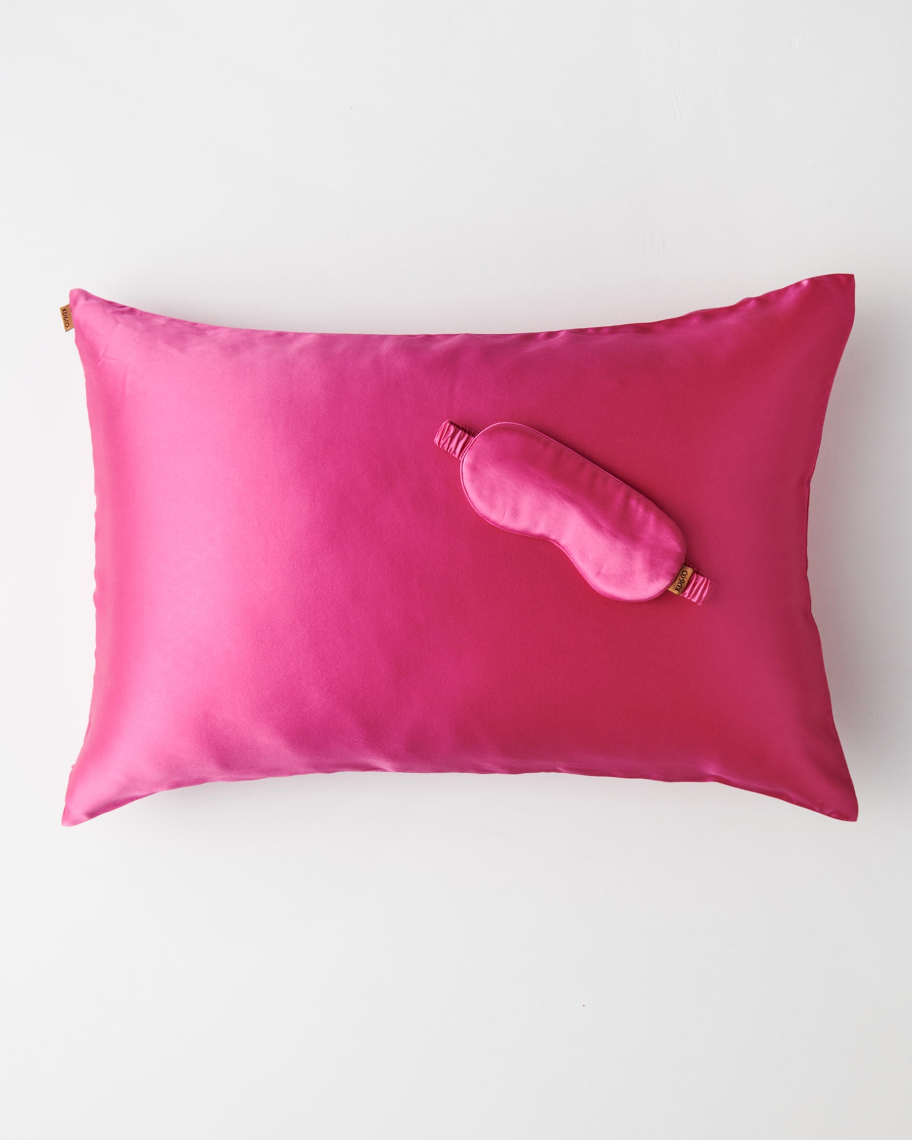 Top view Perfect Pink Silk Eye Mask on matching pink silk pillowcase showing smooth lustrous texture