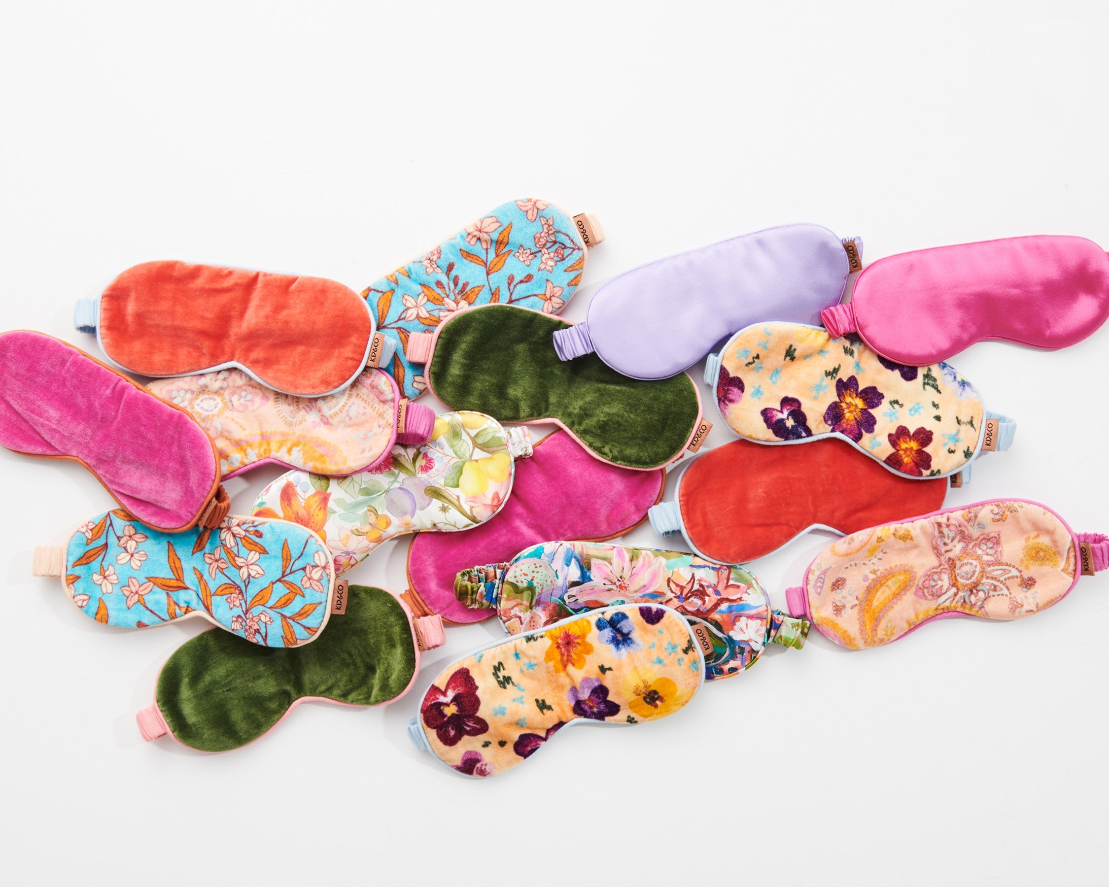 Collection of colorful Kip & Co silk eye masks including Perfect Pink with various floral patterns