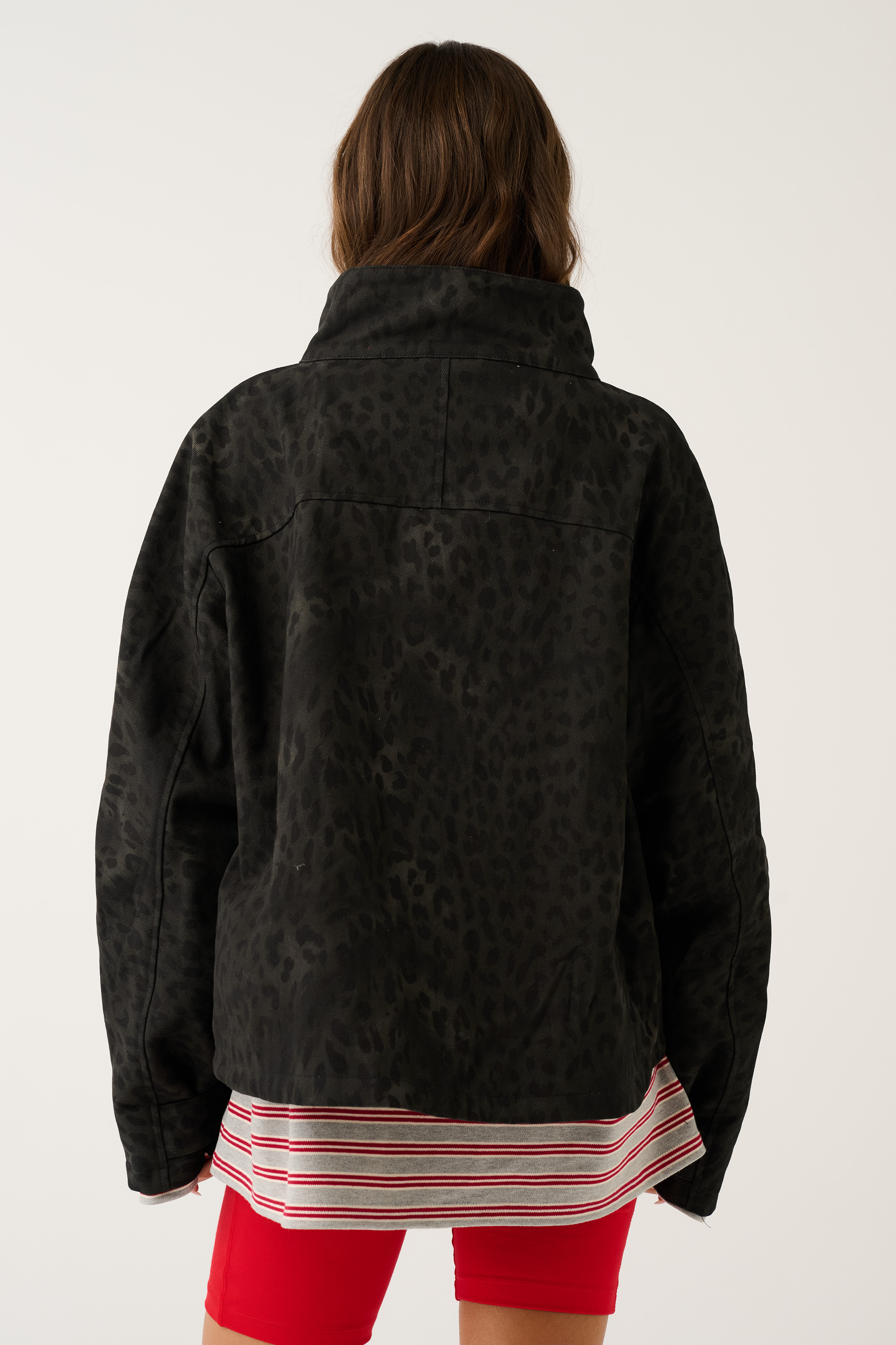 Back view of black washed leopard print oversized jacket showing tonal animal print and high collar