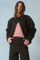 Black washed leopard print jacket worn open with centre zip, oversized drop-shoulder silhouette
