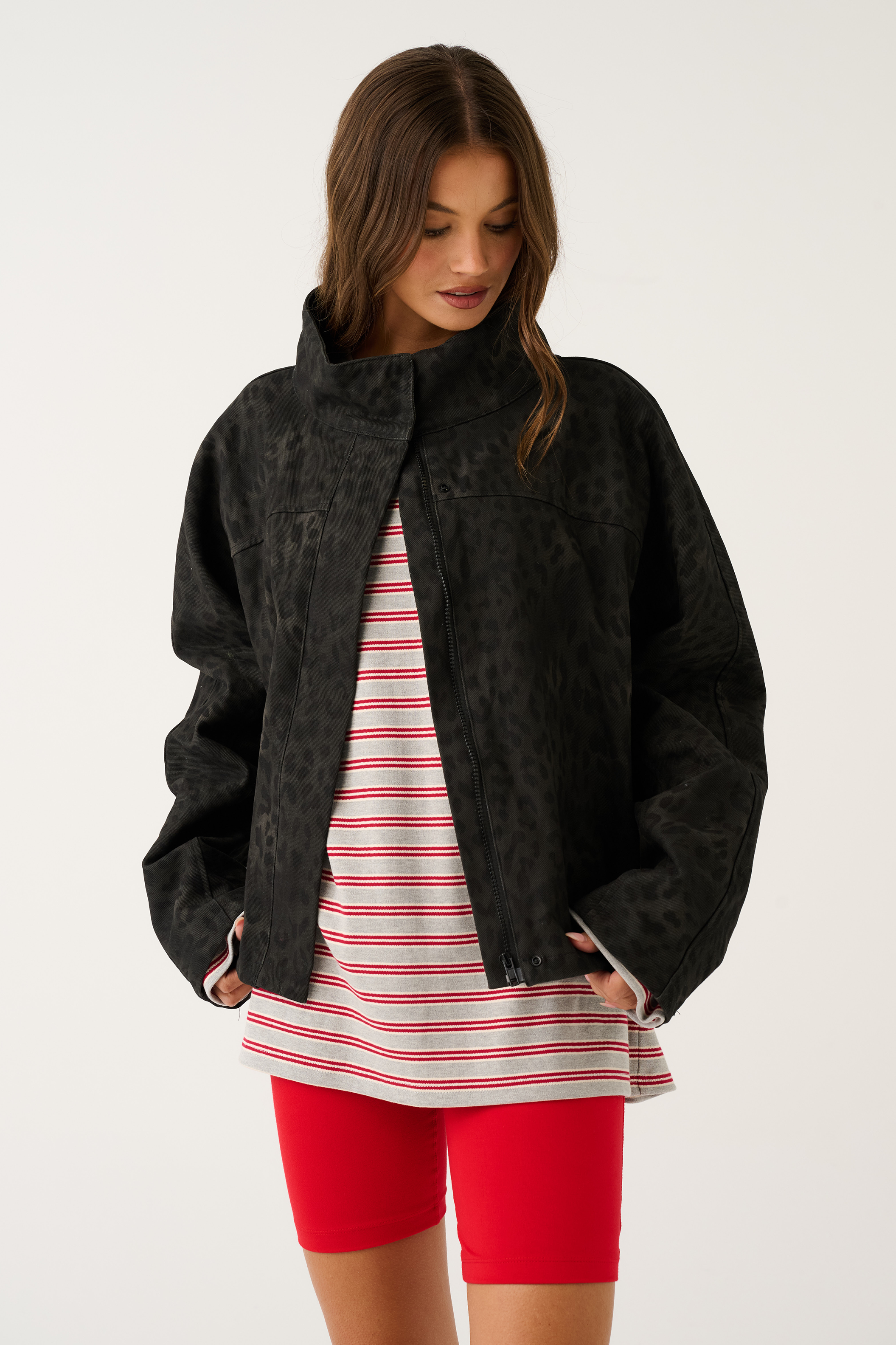 Black washed leopard print oversized jacket worn open showing centre zip, front three-quarter view