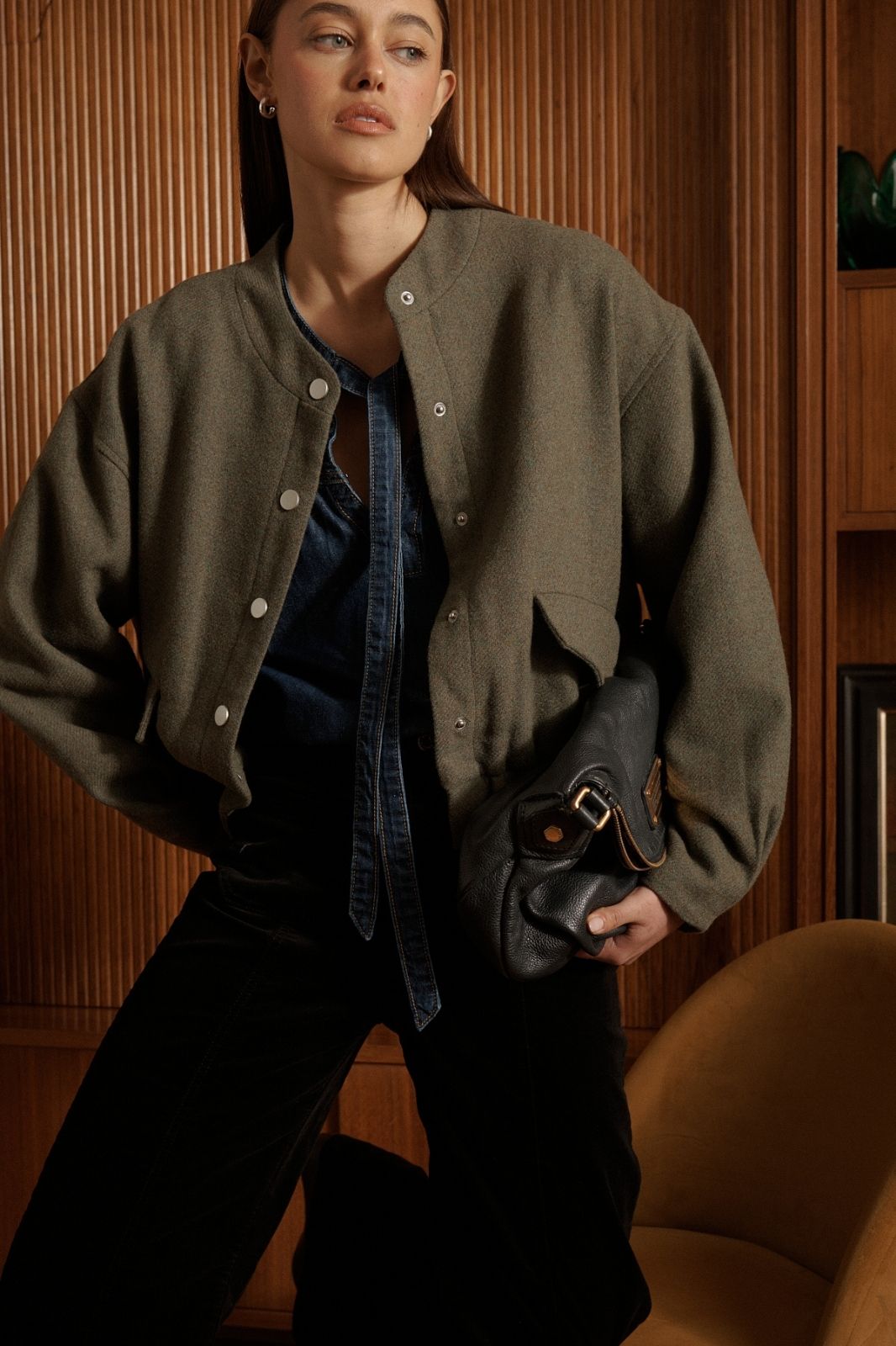Model wearing Kireina Peyton Bomber in khaki styled with jeans for casual luxury streetwear look