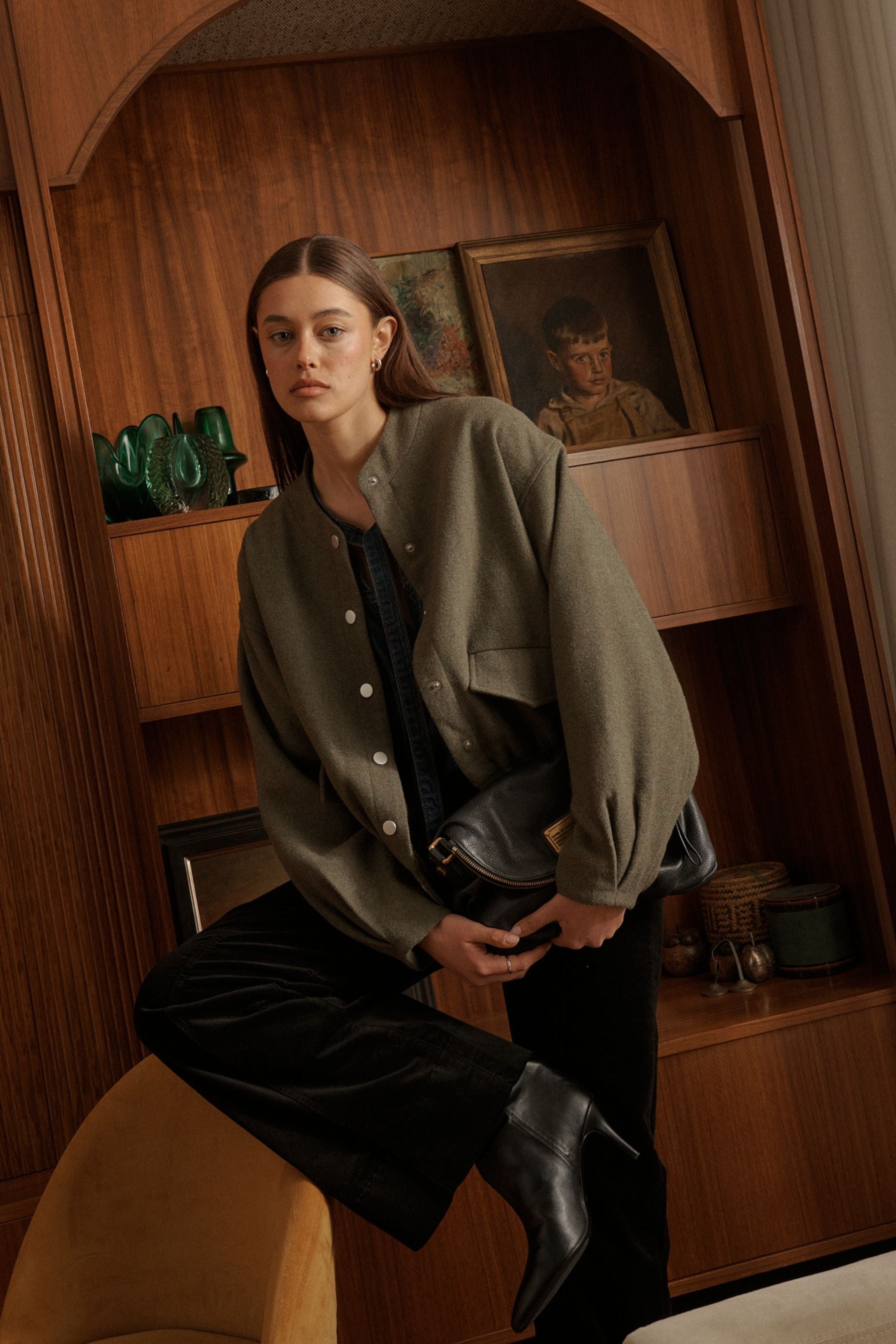 Detail shot of front flap pockets and snap button hardware on Kireina Peyton Bomber jacket