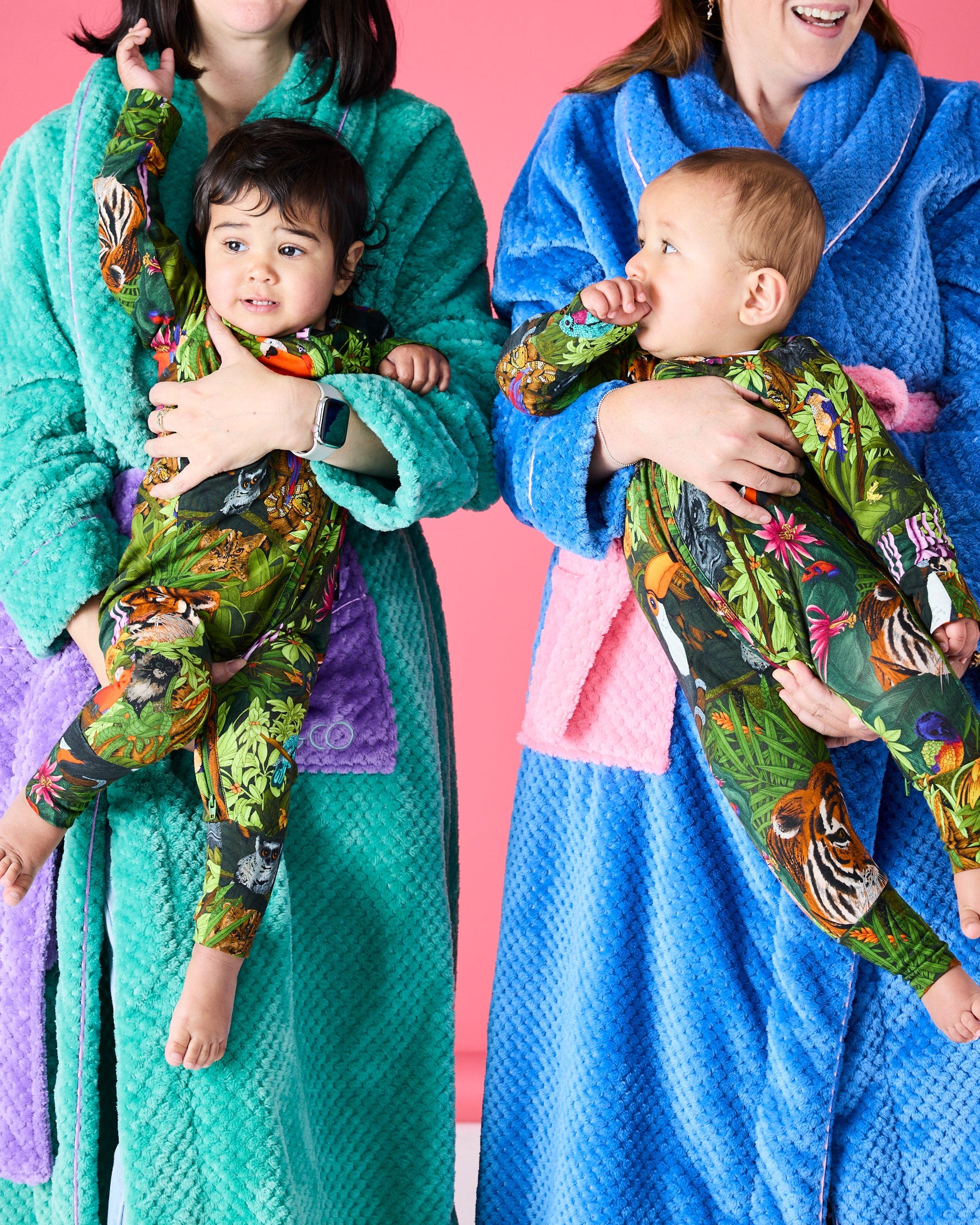 Two mothers and babies wearing blue and green Kip & Co Pie In The Sky cosy robes family styling