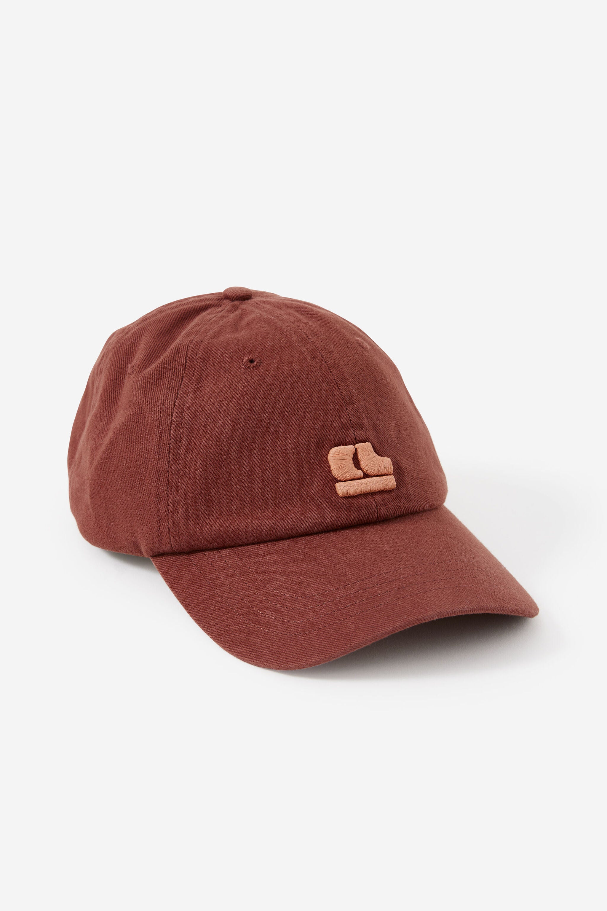 Front view of Pip Everyday Cap in burnt toffee color showing pink clay embroidered logo detail