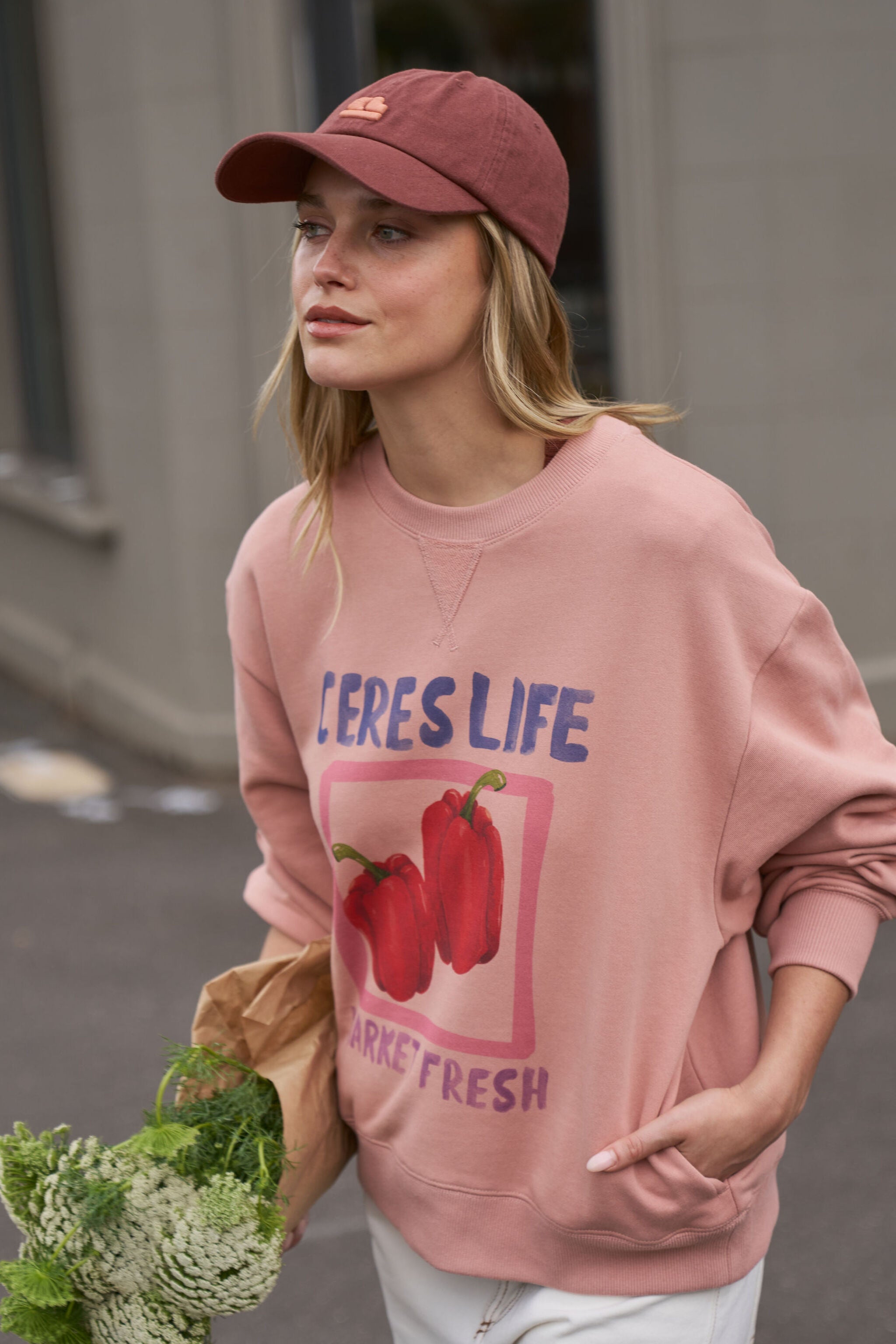Side profile of woman wearing Pip Everyday Cap in burnt toffee with pink clay logo patch