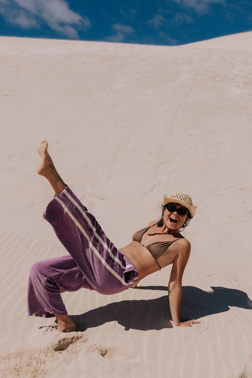 Purple terry towelling pants with stripes down the side