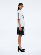 side view of Ena Pelly Racing Pelly Swoop vintage white graphic t-shirt displaying oversized fit and crew neckline