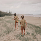 Rad Kid Spliced Cord Shorts by Banabae boys running along the beach wearing the banabae kids shorts