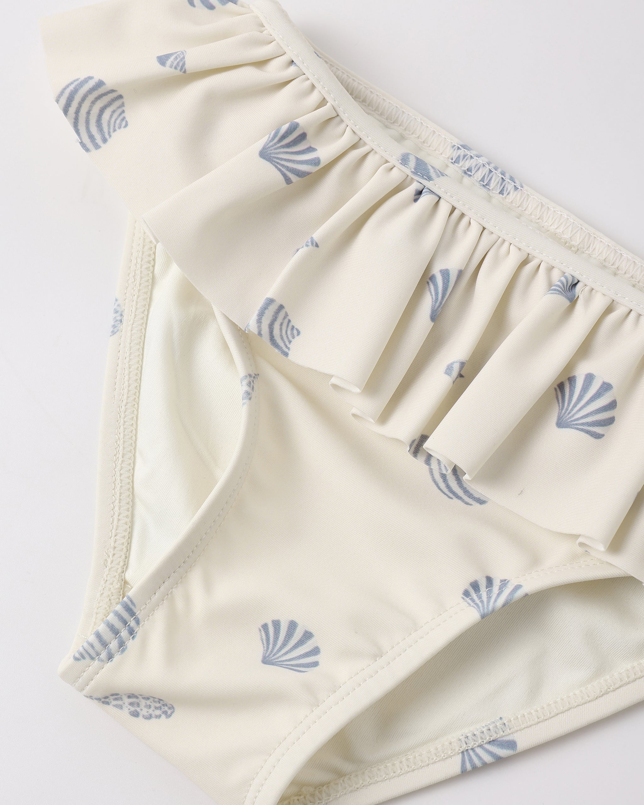 Close up of bottoms on the Rash guard Girls Set Seashells | Rylee + Cru