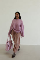 Side angle of Ren Cord Pant in musk pink displaying wide-leg shape and comfortable fit