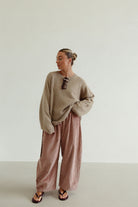 Ren Cord Pant musk pink styled casually with oversized sweater showing relaxed corduroy silhouette