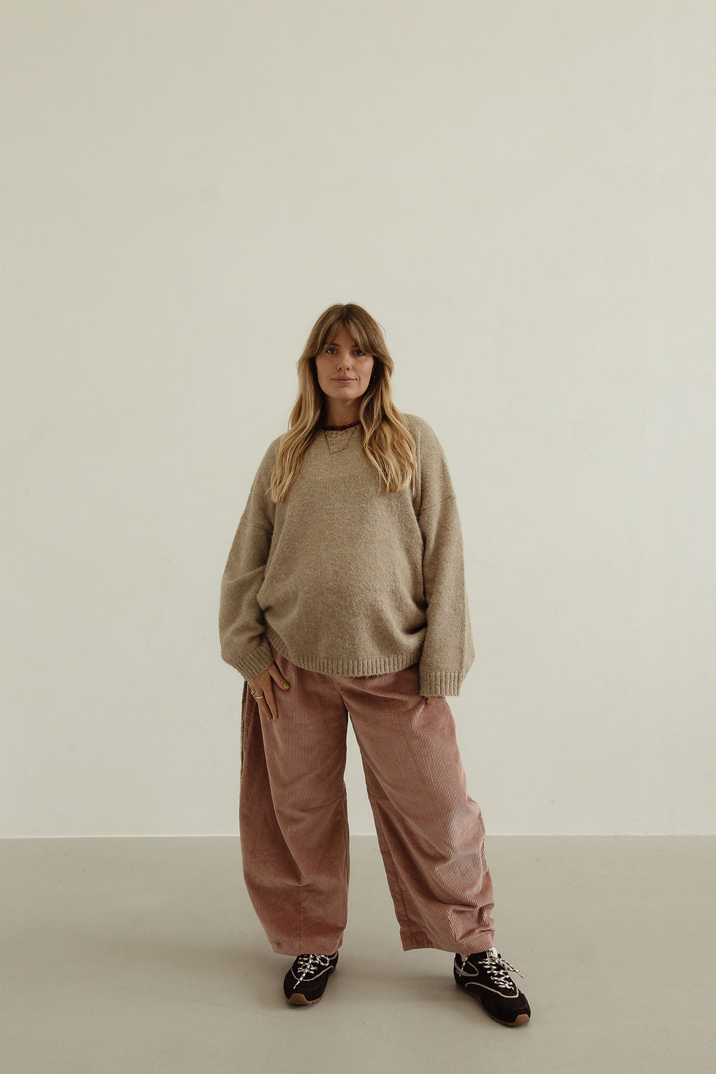 Front view of musk pink corduroy wide-leg pants with relaxed fit and soft drape
