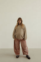 Front view of musk pink corduroy wide-leg pants with relaxed fit and soft drape