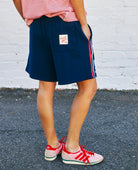 Model wearing navy shorts by Hammill & Co