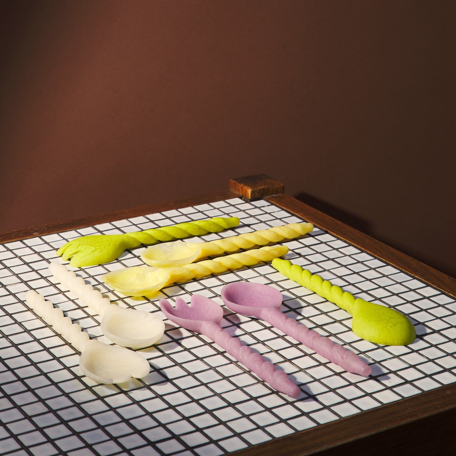 Rose Salad Servers displayed on checkered surface with other kitchen utensils in styled flat lay