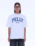 Front detail of Sophia Relaxed Tee featuring blue PELLY Studios collegiate-style lettering on white cotton fabric
