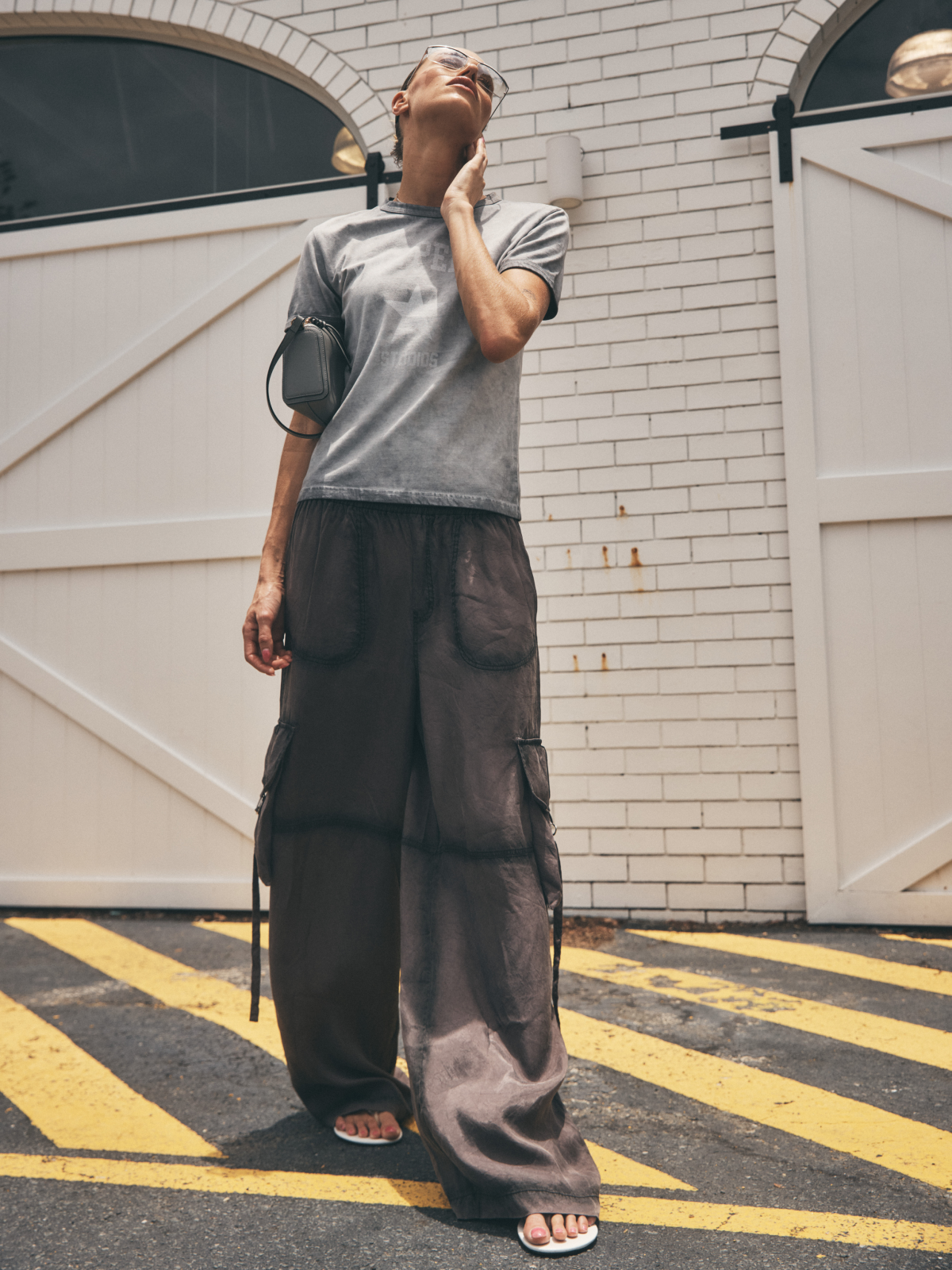 Model wearing Ena Pelly Stardust Utility Pants in relaxed cargo silhouette lifestyle shot