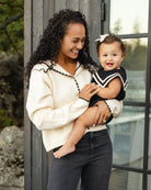 Baby wearing the Sailor Romper Black | Rylee + Cru