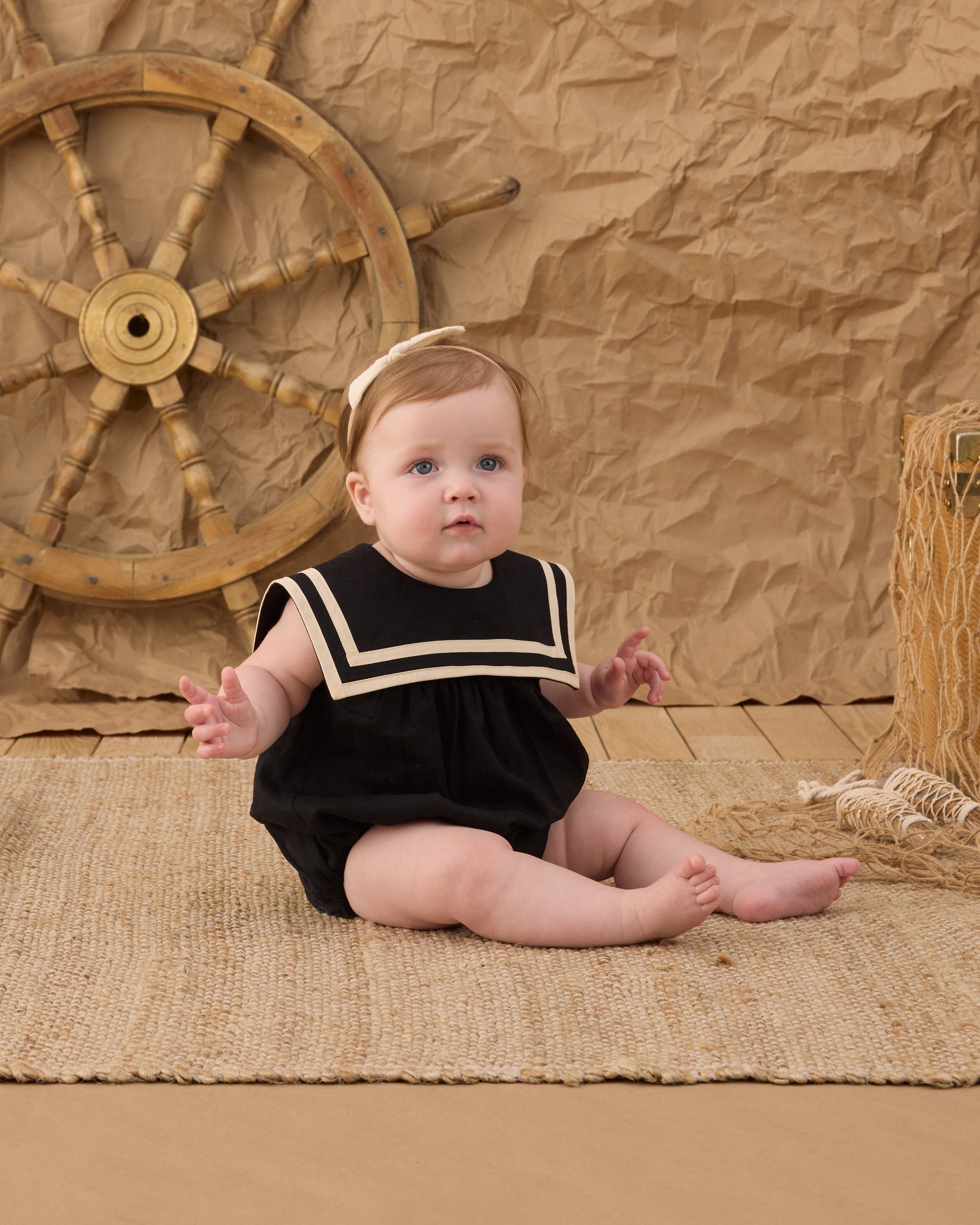 Baby wearing the Sailor Romper Black | Rylee + Cru