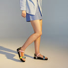model wearing colourful womens leather sandals by rollie - with yellow, pink, orange,  blue and green leather straps