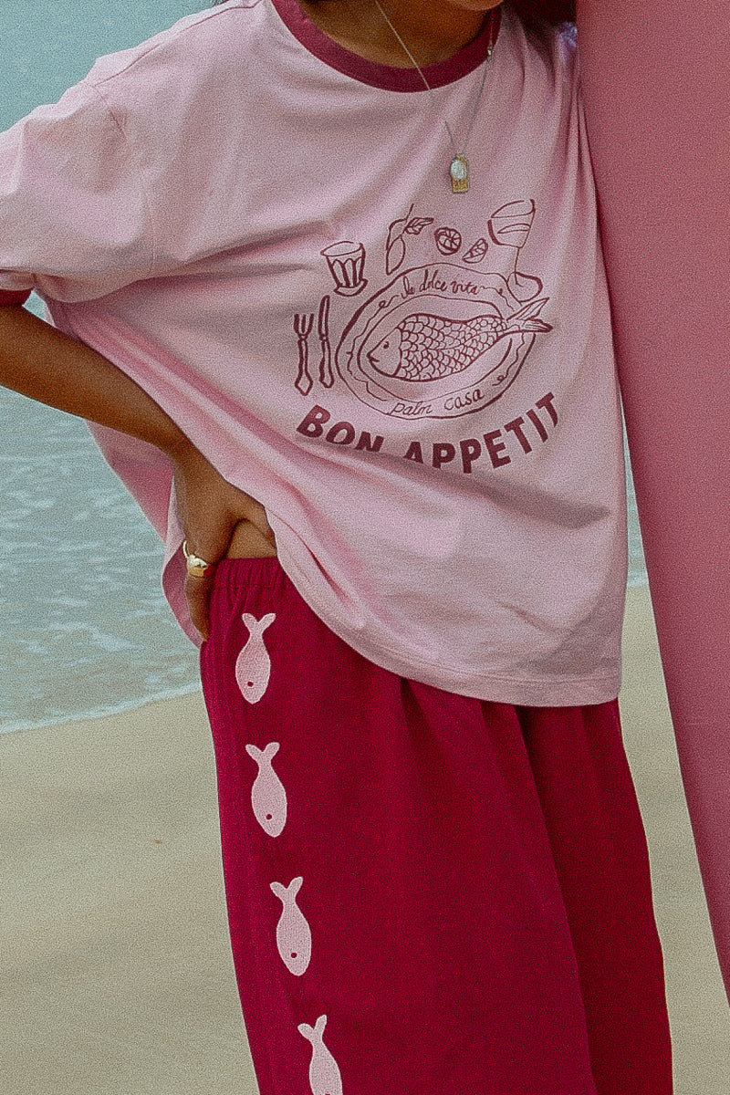 Maroon and pink pants with Sardines down the sides