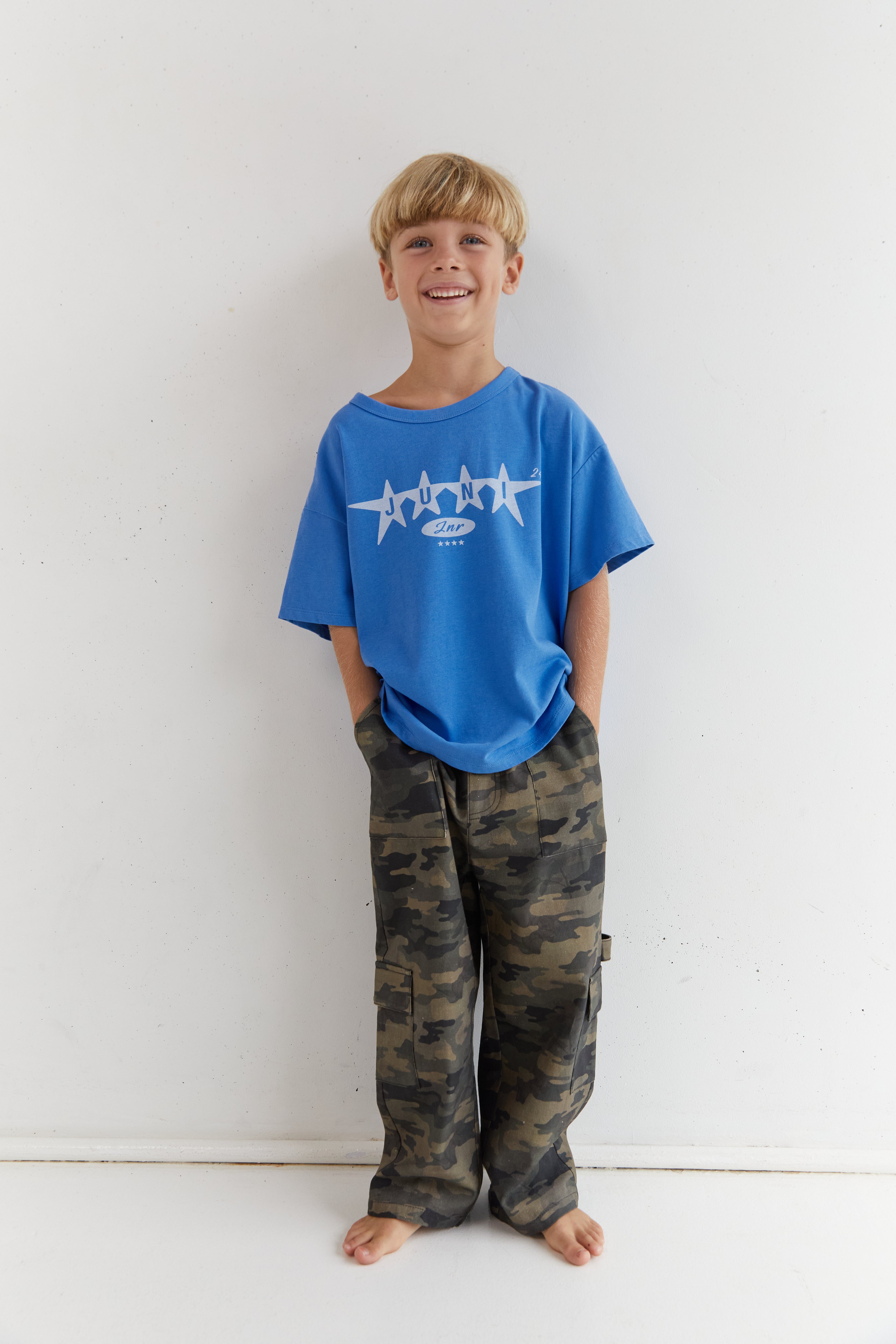Front view of boy in camo Scottie Pants showing full length relaxed cargo style