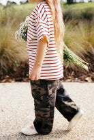 Side view of child in camo Scottie Pants cargo pants showing full length silhouette