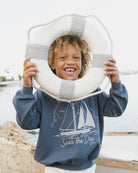 Boy wearing the Seas The Day Sweatshirt  | Rylee + Cru
