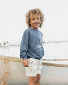Side view of young boy in the Seas The Day Sweatshirt  | Rylee + Cru