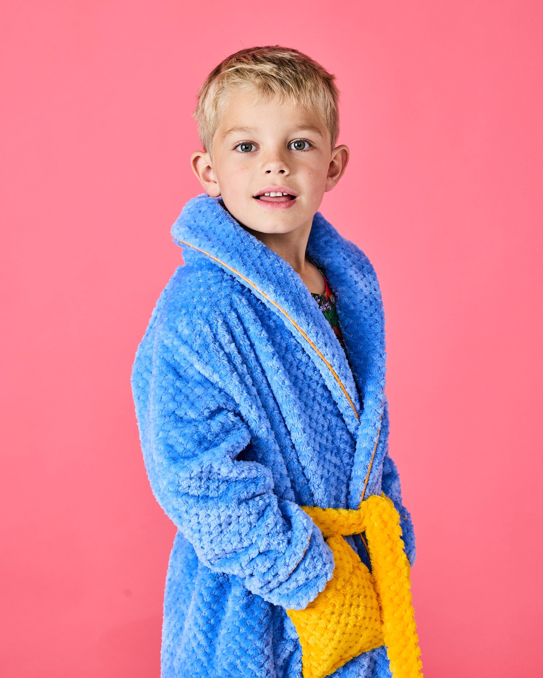 Boy modeling blue Seaside Kids Cosy Robe by Kip & Co with yellow belt showing front view detail